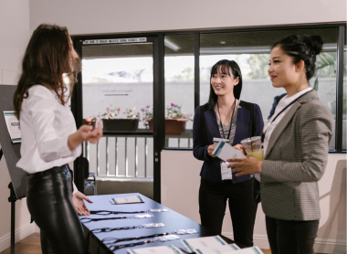 Three women talking at a conference