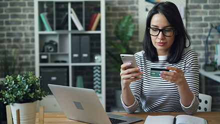 Woman using a credit card to pay online