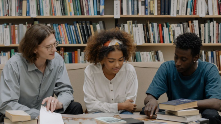 Three students looking at a map