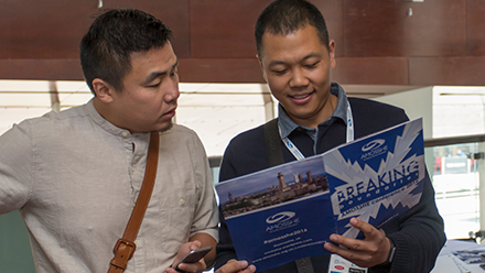 Two men reading a brochure