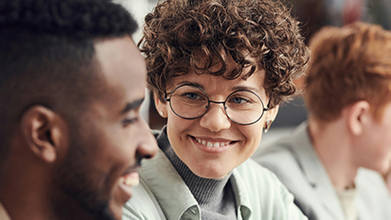 Woman looking at a male colleague and smiling