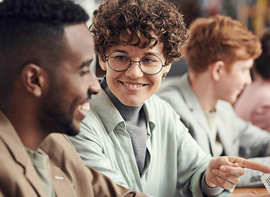 Woman looking at a male colleague and smiling