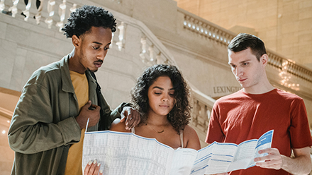 Three students looking at a map